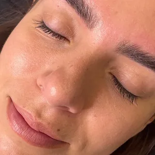 Defined, tinted brows framing the eyes