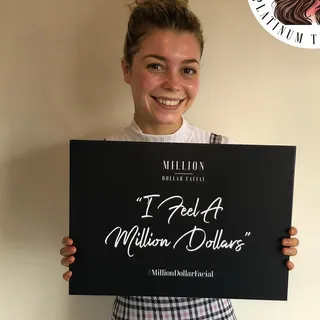 Happy client holding the I Feel A Million Dollars sign