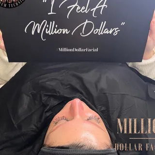 Client holding the I Feel A Million Dollars sign after her facial