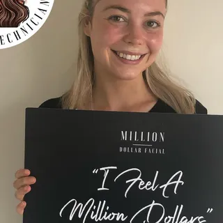 Smiling client with the I Feel A Million Dollars sign